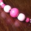 pink bead on leather cord